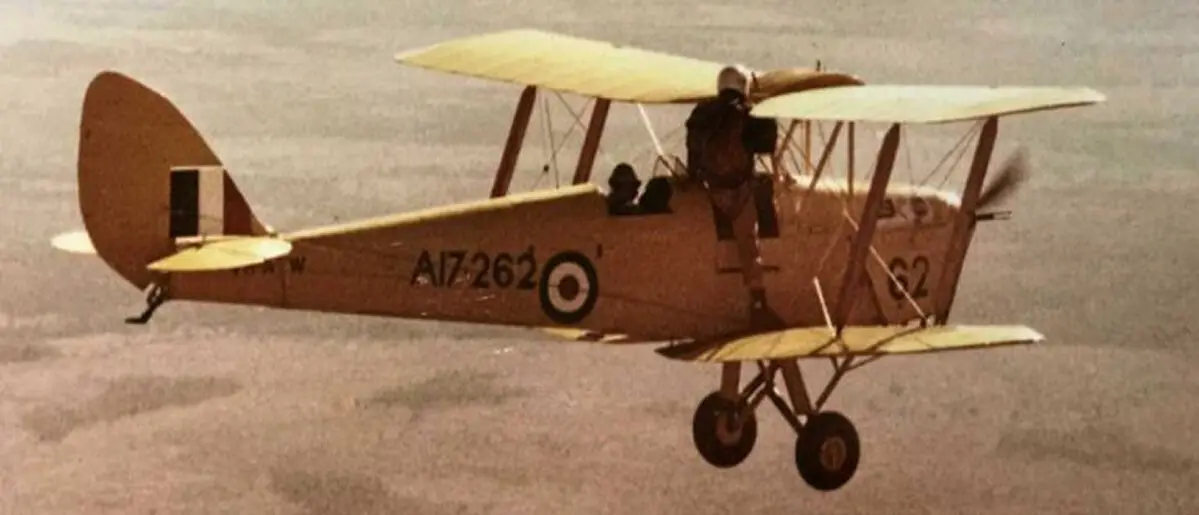 A vintage yellow de Havilland Tiger Moth biplane in flight, featuring Royal Air Force roundels and registration number A17-262, with a pilot visible in the open cockpit. A vintage yellow de Havilland Tiger Moth biplane in flight, featuring Royal Air Force roundels and registration number A17-262, with a pilot visible in the open cockpit.