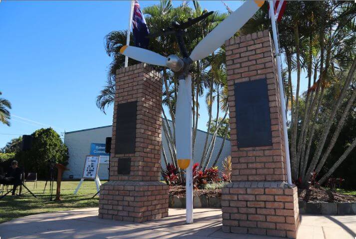 A memorial featuring a mounted aircraft propeller between two brick pillars, dedicated to aviation history